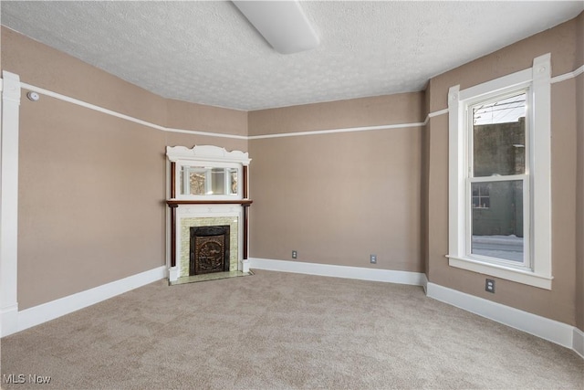 unfurnished living room featuring carpet floors and a textured ceiling