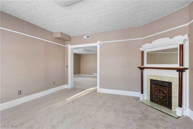 unfurnished living room with light colored carpet and a textured ceiling