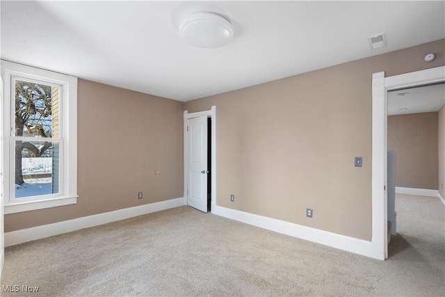 spare room with light colored carpet