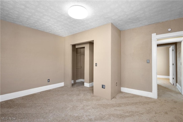 carpeted spare room featuring a textured ceiling