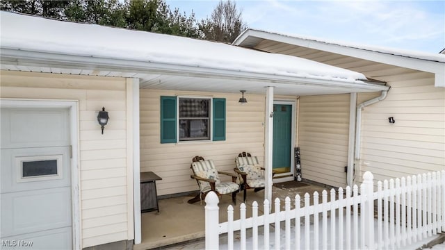 property entrance featuring a garage and covered porch