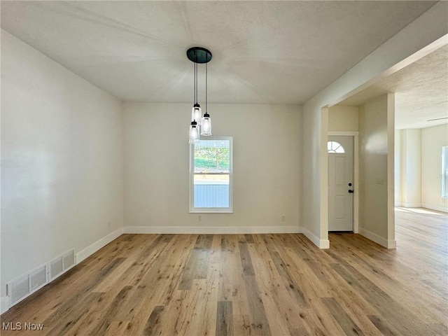 unfurnished dining area with light hardwood / wood-style floors