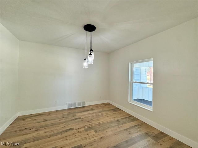 spare room with hardwood / wood-style floors