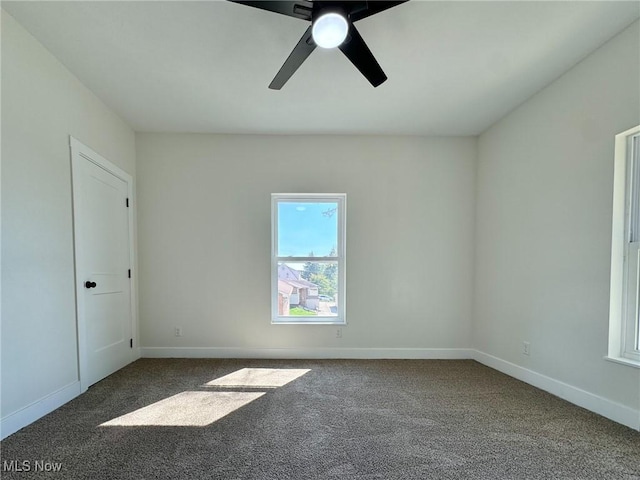 empty room with ceiling fan and carpet floors