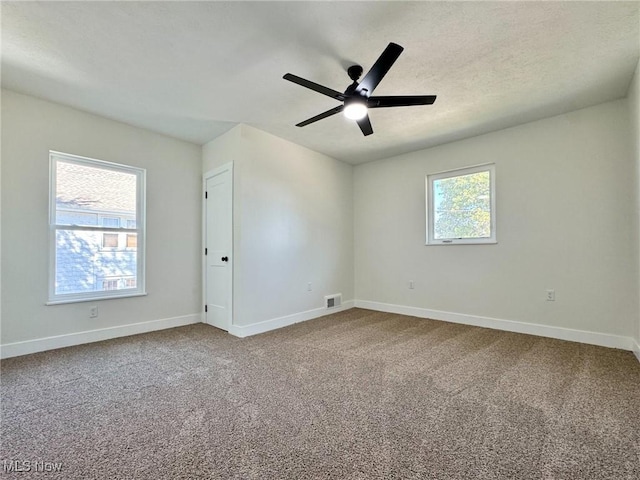 empty room featuring ceiling fan and carpet flooring