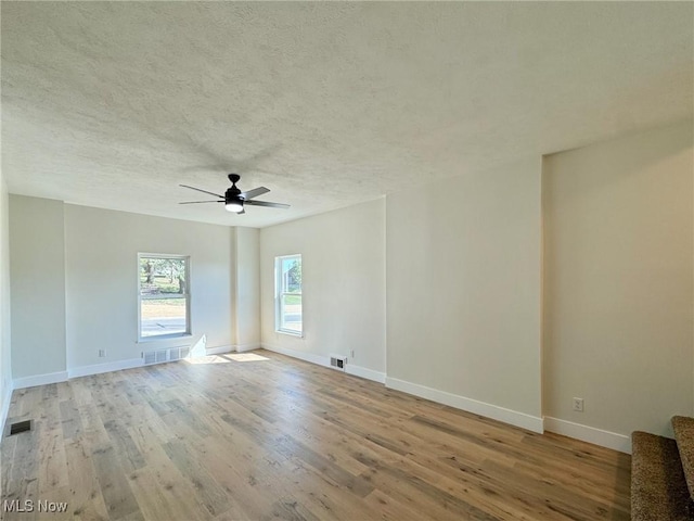 unfurnished room with ceiling fan and light hardwood / wood-style floors