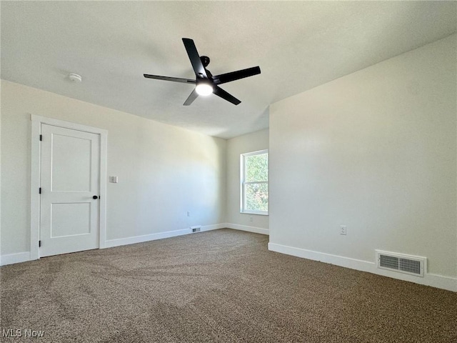 carpeted spare room with ceiling fan