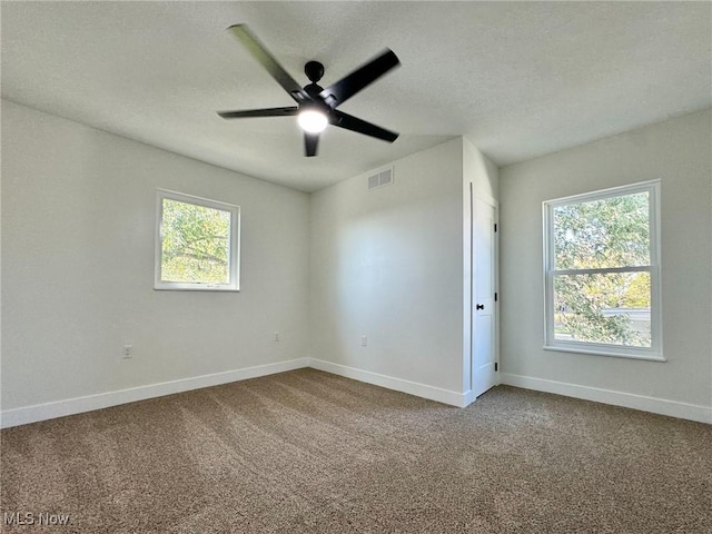 carpeted spare room with ceiling fan