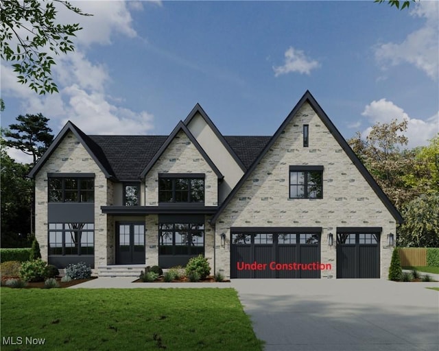 view of front of house with a garage, driveway, and a front yard