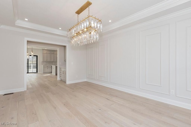 unfurnished dining area featuring recessed lighting, crown molding, light wood finished floors, and an inviting chandelier