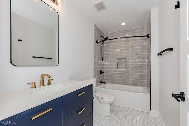 full bath with tile patterned flooring, toilet, vanity, visible vents, and tub / shower combination