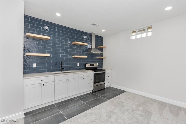 kitchen featuring electric range, a sink, visible vents, wall chimney range hood, and open shelves