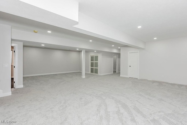 finished below grade area with carpet floors, baseboards, and recessed lighting