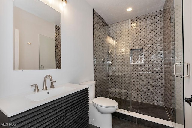 full bathroom with toilet, a shower stall, and vanity