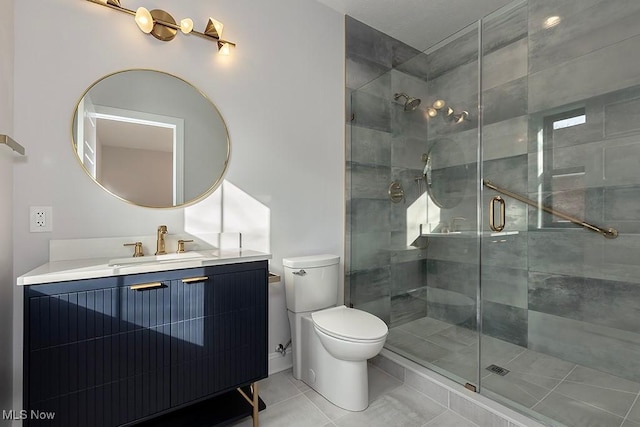 bathroom featuring a stall shower, tile patterned flooring, vanity, and toilet