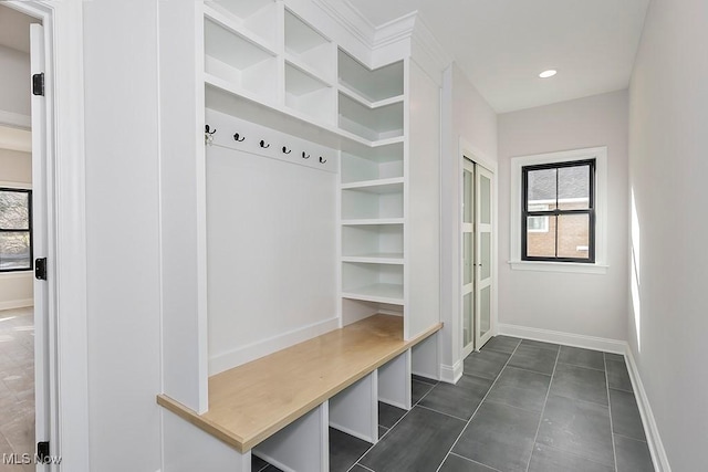 mudroom featuring recessed lighting, plenty of natural light, and baseboards