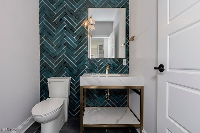 half bath featuring tile patterned flooring, baseboards, tile walls, and toilet