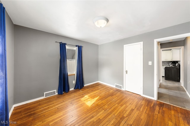 empty room featuring hardwood / wood-style flooring