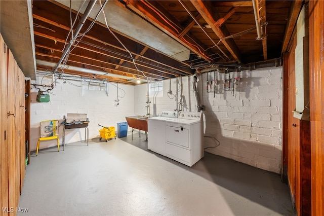 basement featuring sink and washer and dryer