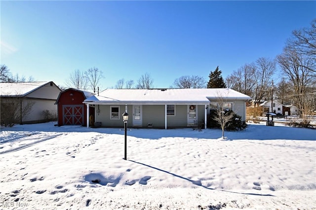 view of front of property with a storage shed