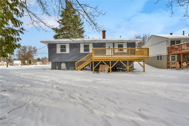 snow covered property with a deck