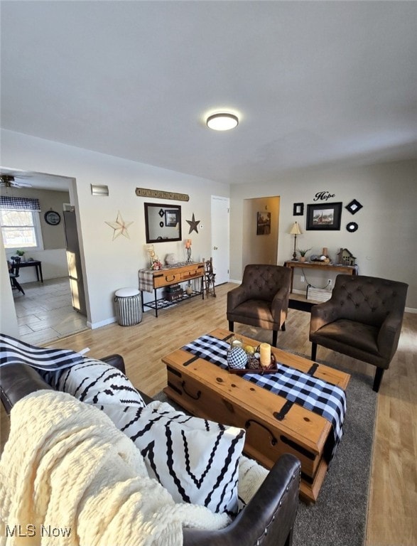 living room with hardwood / wood-style floors and ceiling fan