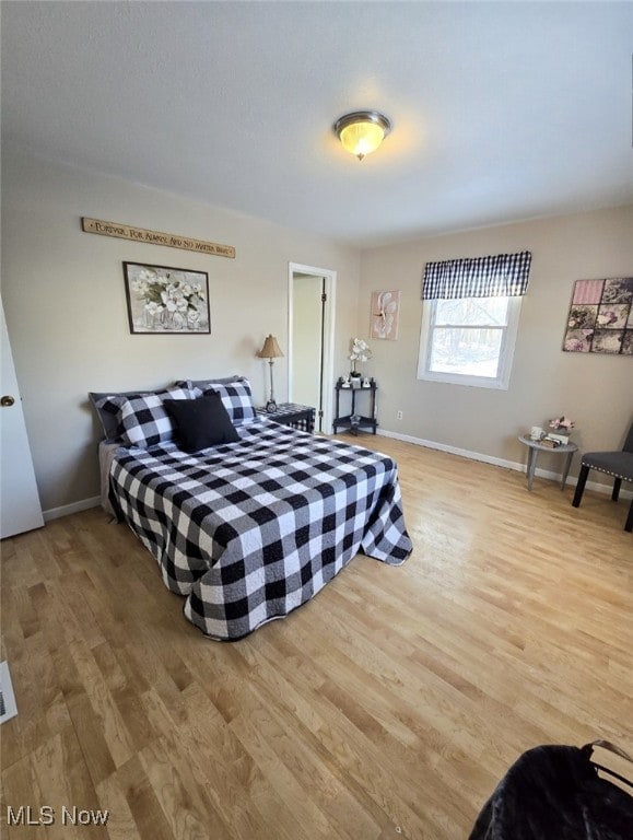 bedroom with hardwood / wood-style floors