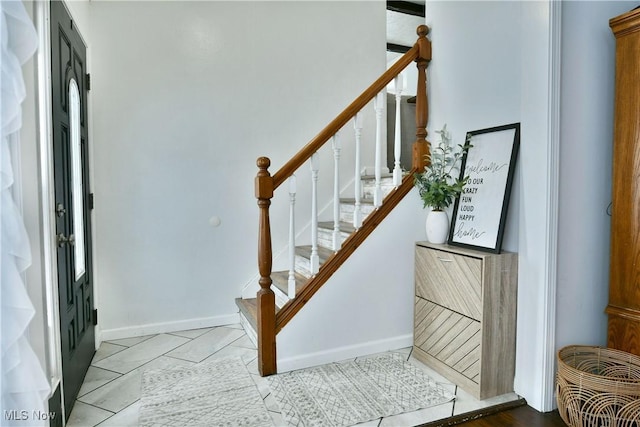 stairs featuring tile patterned floors