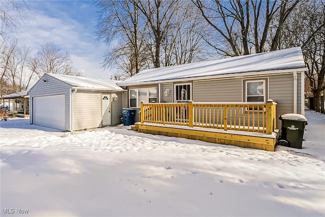 exterior space with a garage, a deck, and an outdoor structure