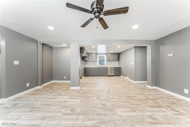 unfurnished living room featuring ceiling fan, sink, and light hardwood / wood-style flooring