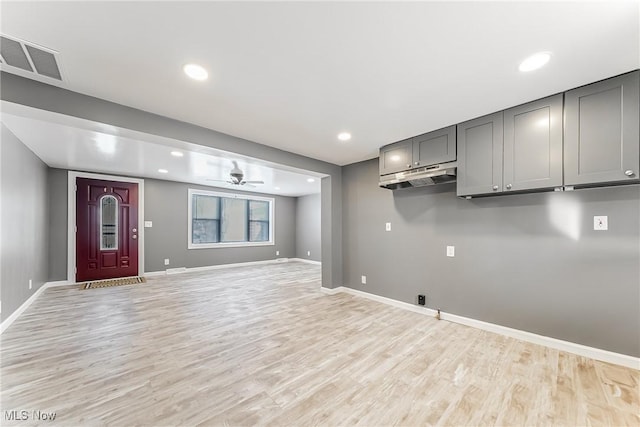 interior space with ceiling fan and light wood-type flooring