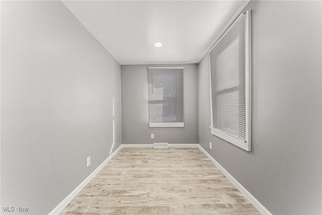 spare room featuring light hardwood / wood-style flooring