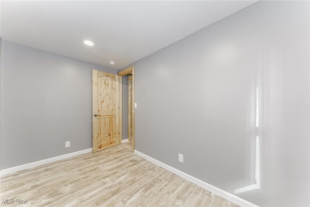 unfurnished room with light hardwood / wood-style floors