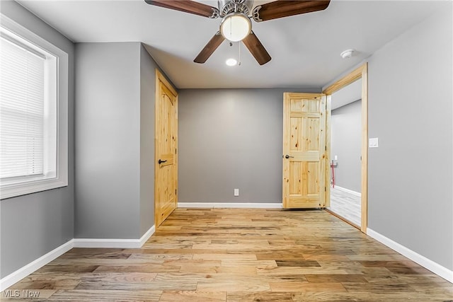 unfurnished bedroom featuring light wood-type flooring and ceiling fan