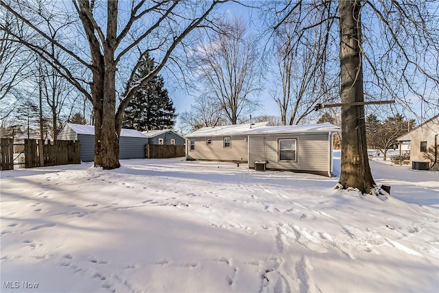 snow covered property featuring central air condition unit