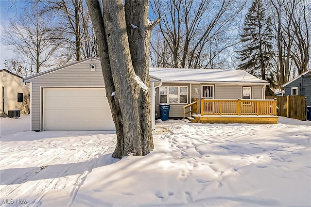 ranch-style house with central air condition unit, a deck, and a garage