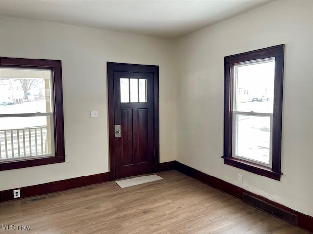 entryway with light hardwood / wood-style floors