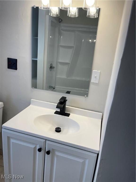 bathroom with vanity and  shower combination