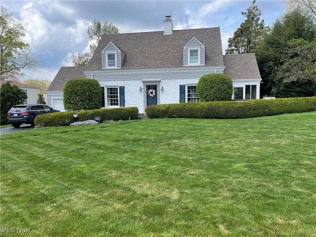 cape cod house with a garage and a front lawn