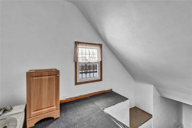 bonus room featuring lofted ceiling and carpet flooring