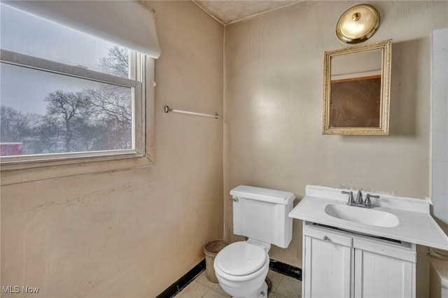 bathroom featuring toilet, tile patterned floors, and vanity