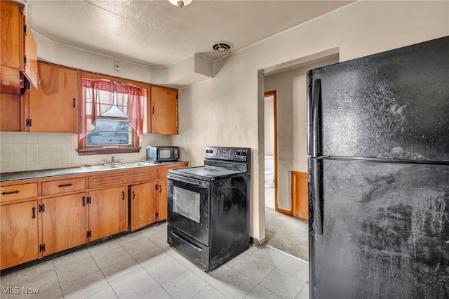 kitchen with sink, backsplash, and black appliances