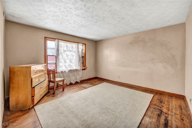 living area featuring a textured ceiling and light wood-type flooring