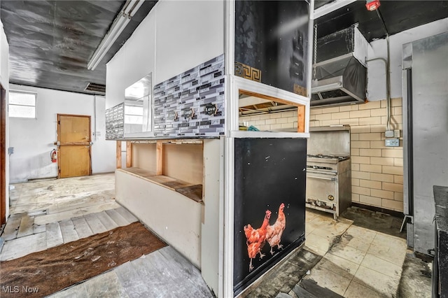 kitchen with tasteful backsplash and white cabinetry