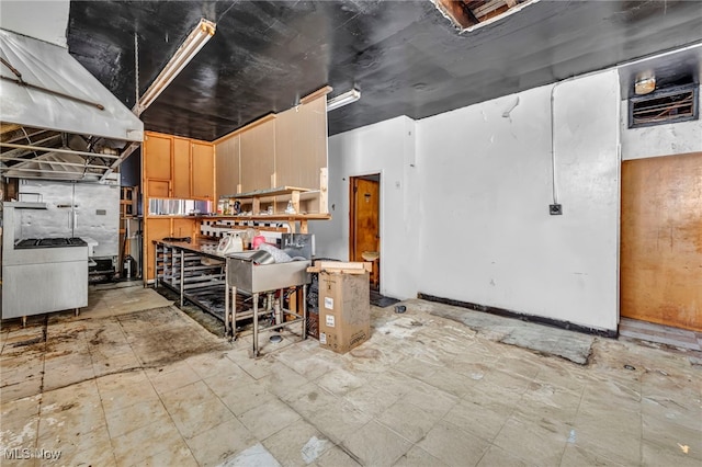 kitchen featuring light brown cabinetry