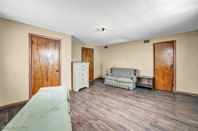 sitting room with dark wood-type flooring