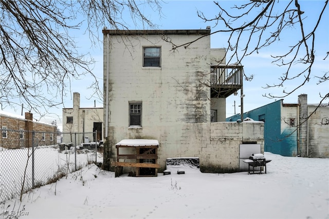 snow covered house with a balcony