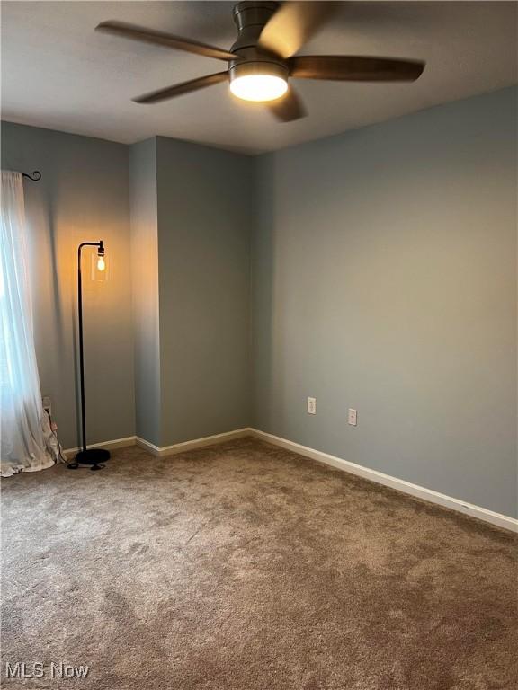 carpeted empty room with ceiling fan