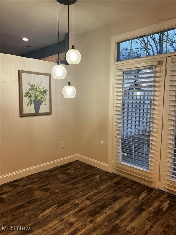 spare room featuring dark wood-type flooring