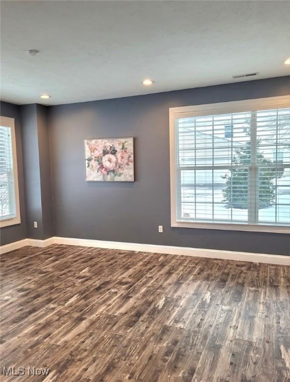 spare room with wood-type flooring